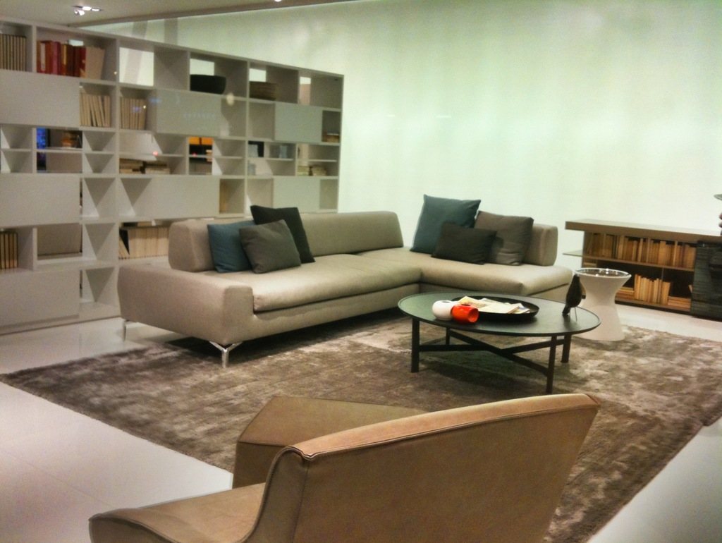 Modern living room with a pale sofa and shelving